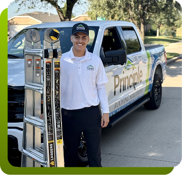 principle roofing employee standing by company truck 
